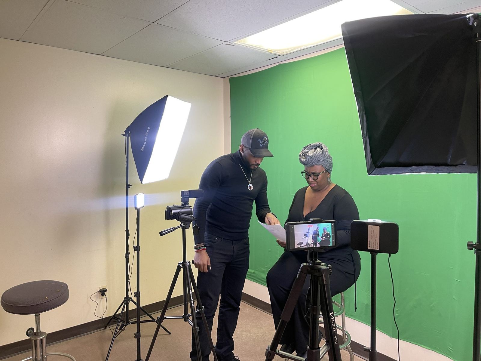 Pathworth directing a video shoot on set, lights and cameras up.