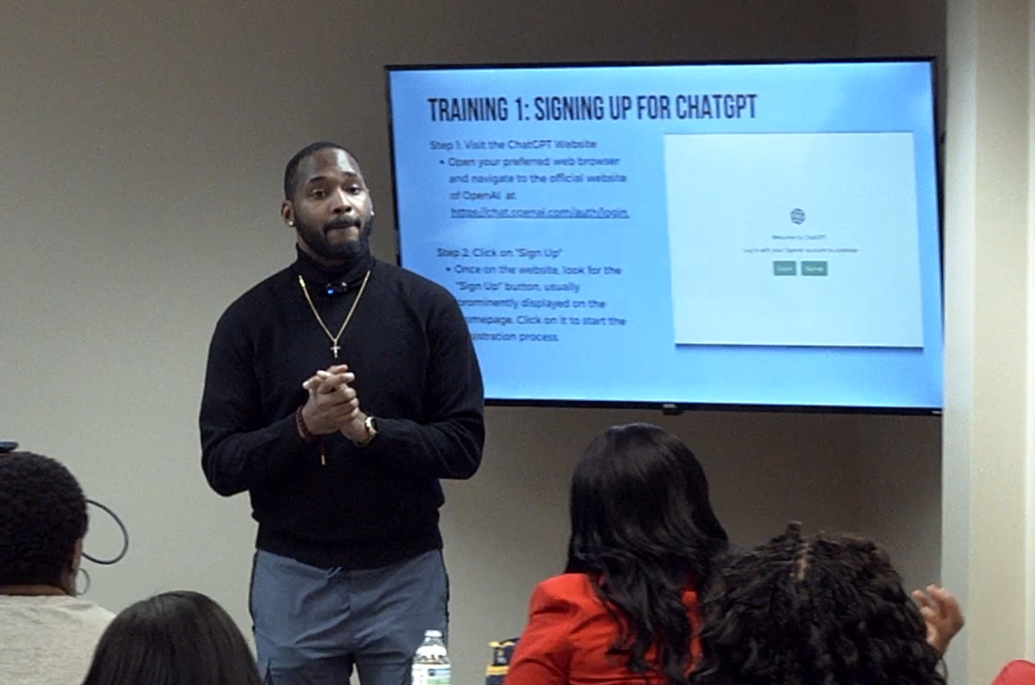Standing in front of a full room, walking a team through the tools on the screen behind.